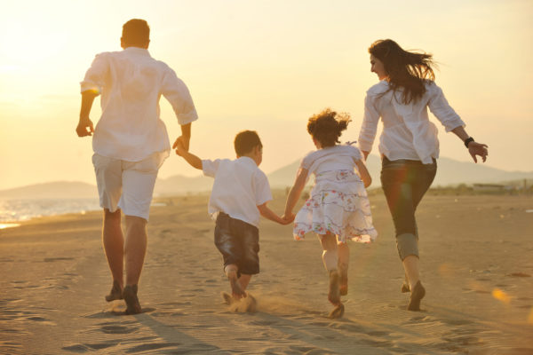 Happy Family On The Beach